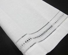 a close up of a white napkin on a black table cloth with circles and dots