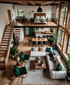 a living room filled with lots of furniture next to a stair case in a house