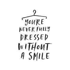 a black and white quote that says, you're never fully dressed without a smile