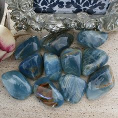 some blue stones and a rose on a table