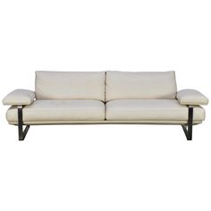 a white couch sitting on top of a wooden frame