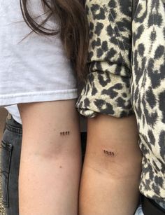 two people with matching tattoos on their arms