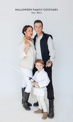 a man, woman and child dressed up as star wars characters