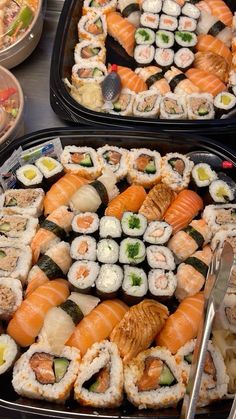 two trays filled with different types of sushi