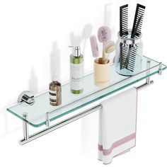 a glass shelf with two toothbrushes, soap and other bathroom items on it