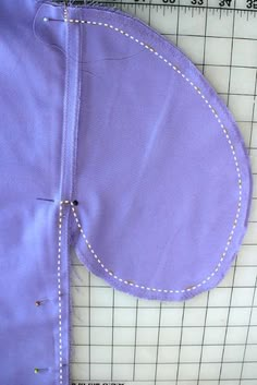 a piece of purple material with white stitching