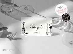 there is a sign that says magnet next to wine glasses