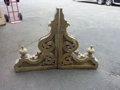 a pair of wooden gates sitting on top of a cement ground next to a red fire hydrant