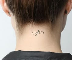 a woman with a small tattoo on her neck