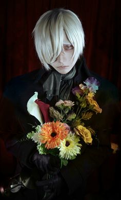 a man with white hair holding a bouquet of flowers