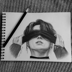 a pencil drawing of a woman's face with blindfolds over her eyes