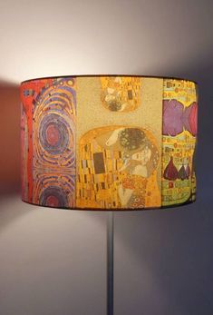 a lampshade with an artistic painting on it