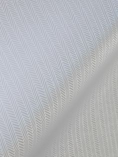 close up view of white fabric with wavy lines on the back and side of it