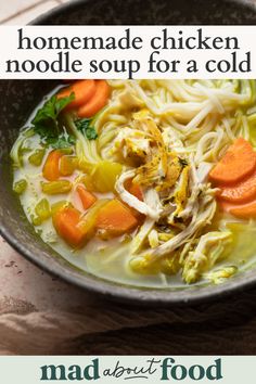 a bowl of chicken noodle soup with carrots and noodles