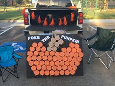 an orange pumpkin shaped sign sitting in the back of a truck