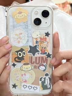 a person holding up a cell phone case with stickers on it