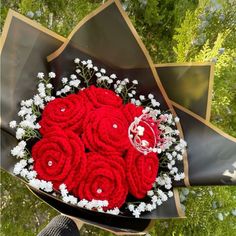 a bouquet of red roses and baby's breath