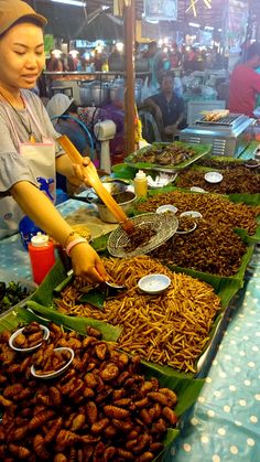 a woman preparing food at an outdoor market