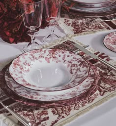 the table is set with red and white china