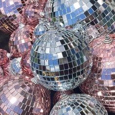 many shiny disco balls are stacked on top of each other