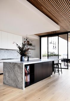 a kitchen with marble counter tops and wooden floors