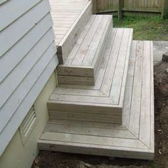 the steps are made out of wood and have been placed on the side of the house