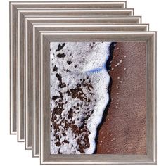 four framed photographs of the beach and water in silver frames on a white background, each with