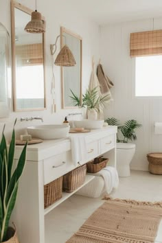 a bathroom with two sinks, mirrors and baskets on the floor