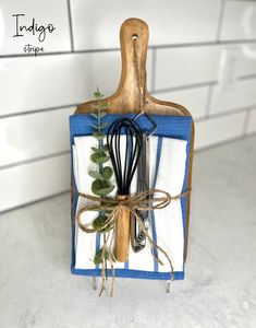 a kitchen utensil holder made out of an old cutting board and whisk