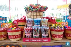 candy and lollipops are on display in baskets