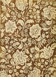 an intricately designed brown and white rug with floral designs on it's sides