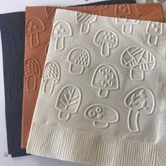 three napkins with different designs on them