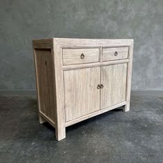 a white wooden cabinet with two drawers