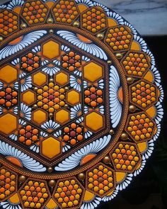 an orange and white plate sitting on top of a table