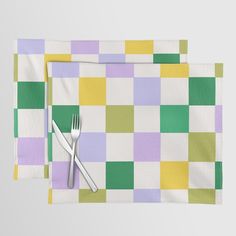 two placemats with forks on them are sitting next to each other in front of a white background