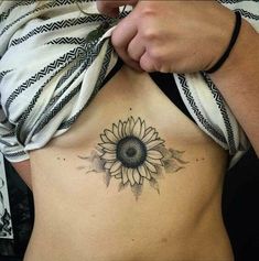 a woman with a sunflower tattoo on her stomach