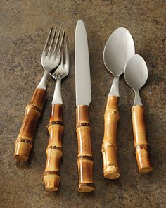 four forks, spoons and two knives are arranged in the shape of bamboo sticks