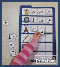 a young child is playing with the alphabet game