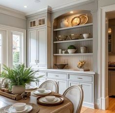 a dining room table with plates and bowls on it