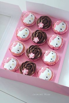 hello kitty cupcakes with chocolate frosting in a pink box