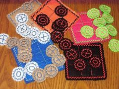 four pieces of crocheted rugs on a wooden floor with flowers in them