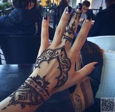 a woman's hand with henna on it