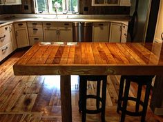 a kitchen with an island made out of wood