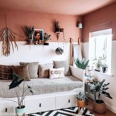 a living room filled with furniture and plants