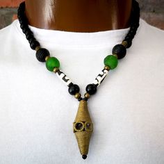 Batik bone, glass and brass bead  necklace ~ D E T A I L S ~ ~  8 + 10mm  black wood beads ~  batik bone beads ~  brass beads ~  handmade glass beads from .   Ghana ~  handmade brass pendant from .   Ghana ~  handmade necklace ~  the wood beads are imperfect NECKLACE LENGTH on mannequin  is 20" ~ S H I P P I N G ~ Please see the Announcement on  our shop Bead Necklace Men, African Necklaces, Bead Pendant Necklace, Mens Beaded Necklaces, Men's Necklaces, Necklace Mens, African Necklace, Mens Necklace, Wood Bead Necklace