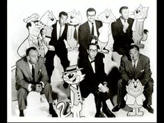 a group of men in suits and ties posing for a photo with cartoon characters behind them