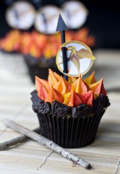 a cupcake decorated with orange and black decorations