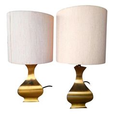 pair of brass table lamps with white shades