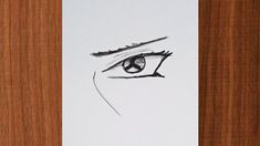 a piece of paper with a drawing of a woman's eye on top of it