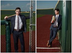 a man in a suit leaning on a fence holding a baseball bat and glove while wearing a catchers mitt